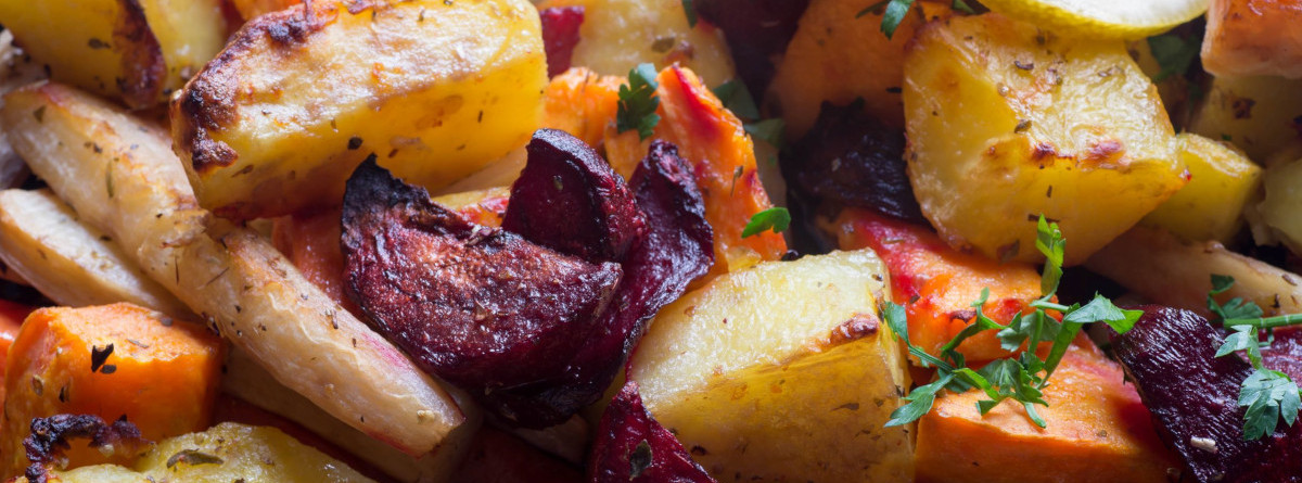 An assortment of roasted root vegetables with fresh herbs