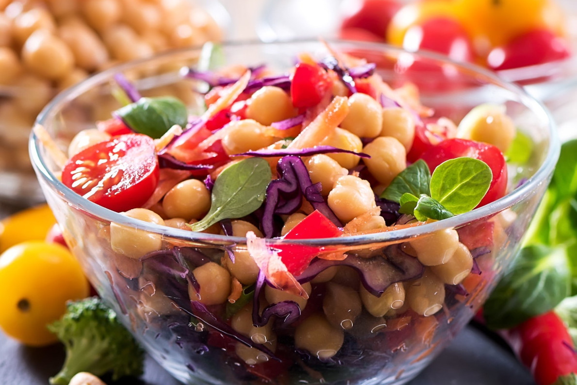 A bowl of bean salad with vegetables