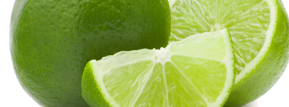 A whole lime next to slices of lime
