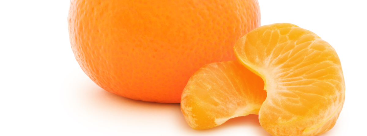 Fresh orange slices next to a whole orange