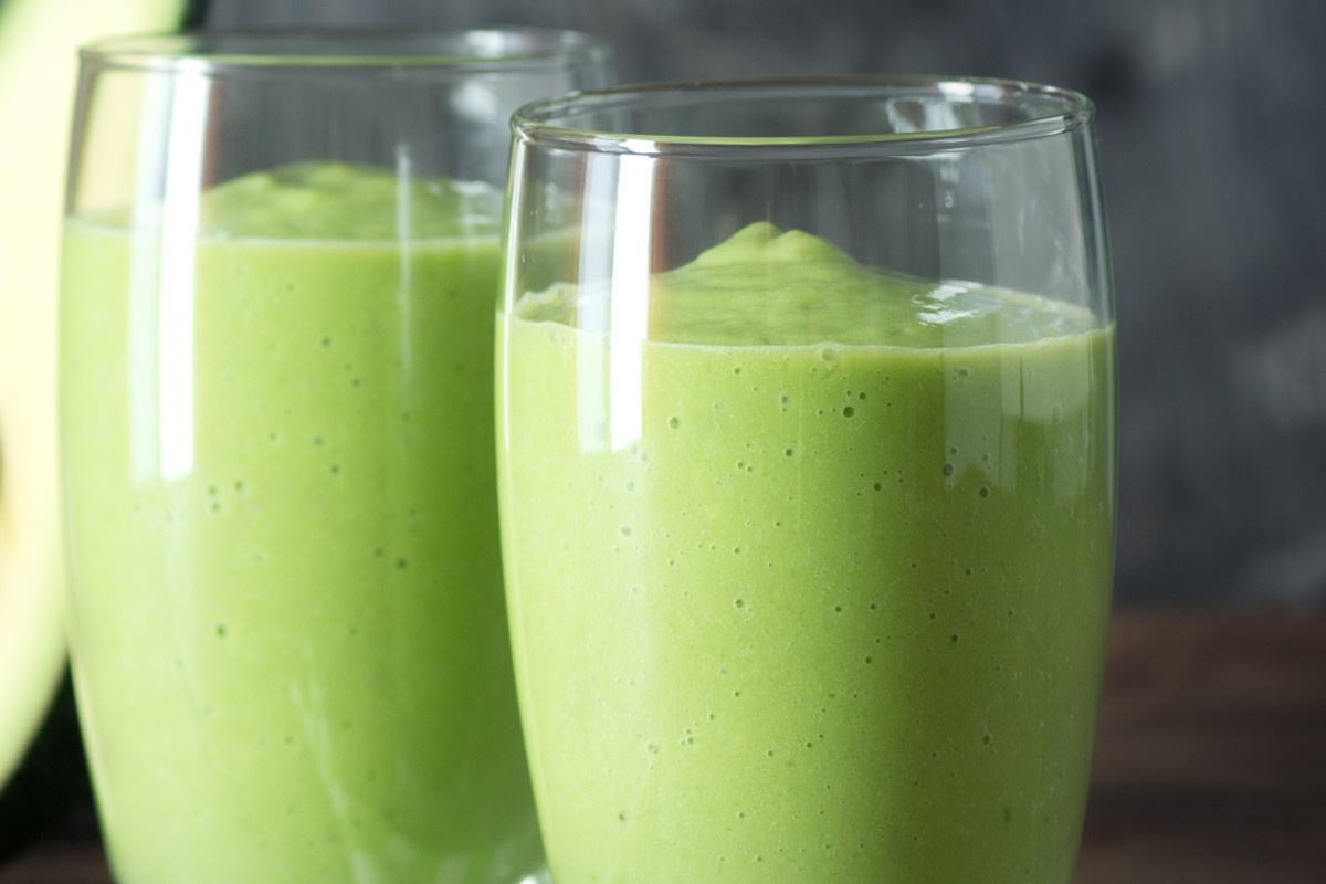 Two glasses of a green avocado smoothie