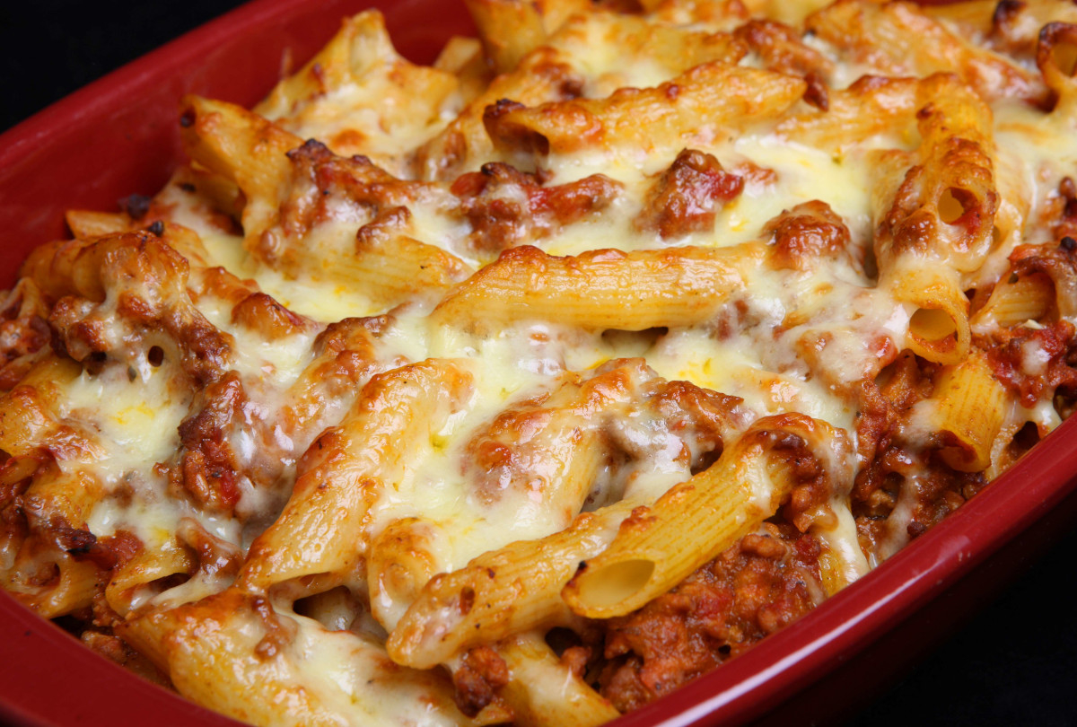 A dish of baked pasta with cheese and meat sauce