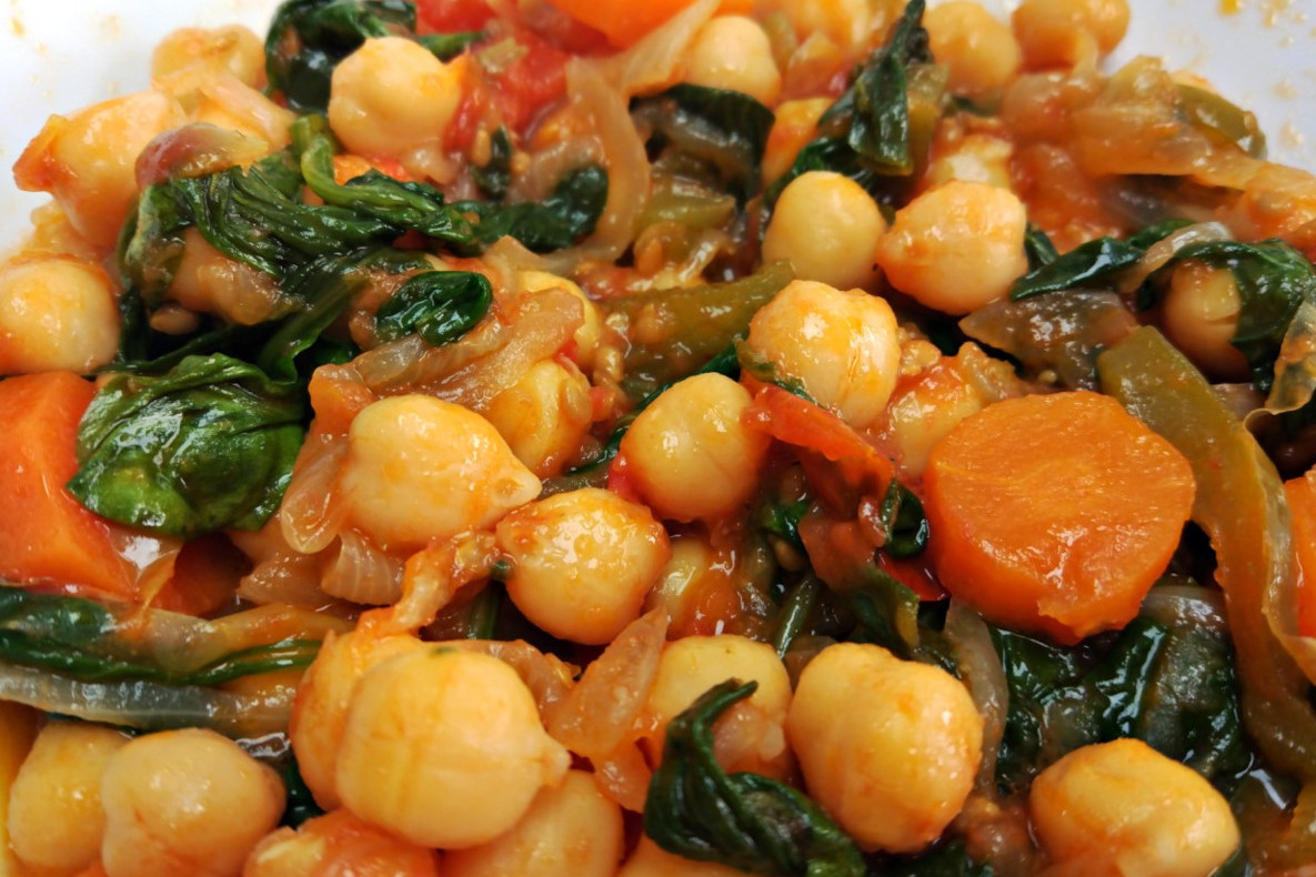 A bowl of sauteed chickpeas with spinach