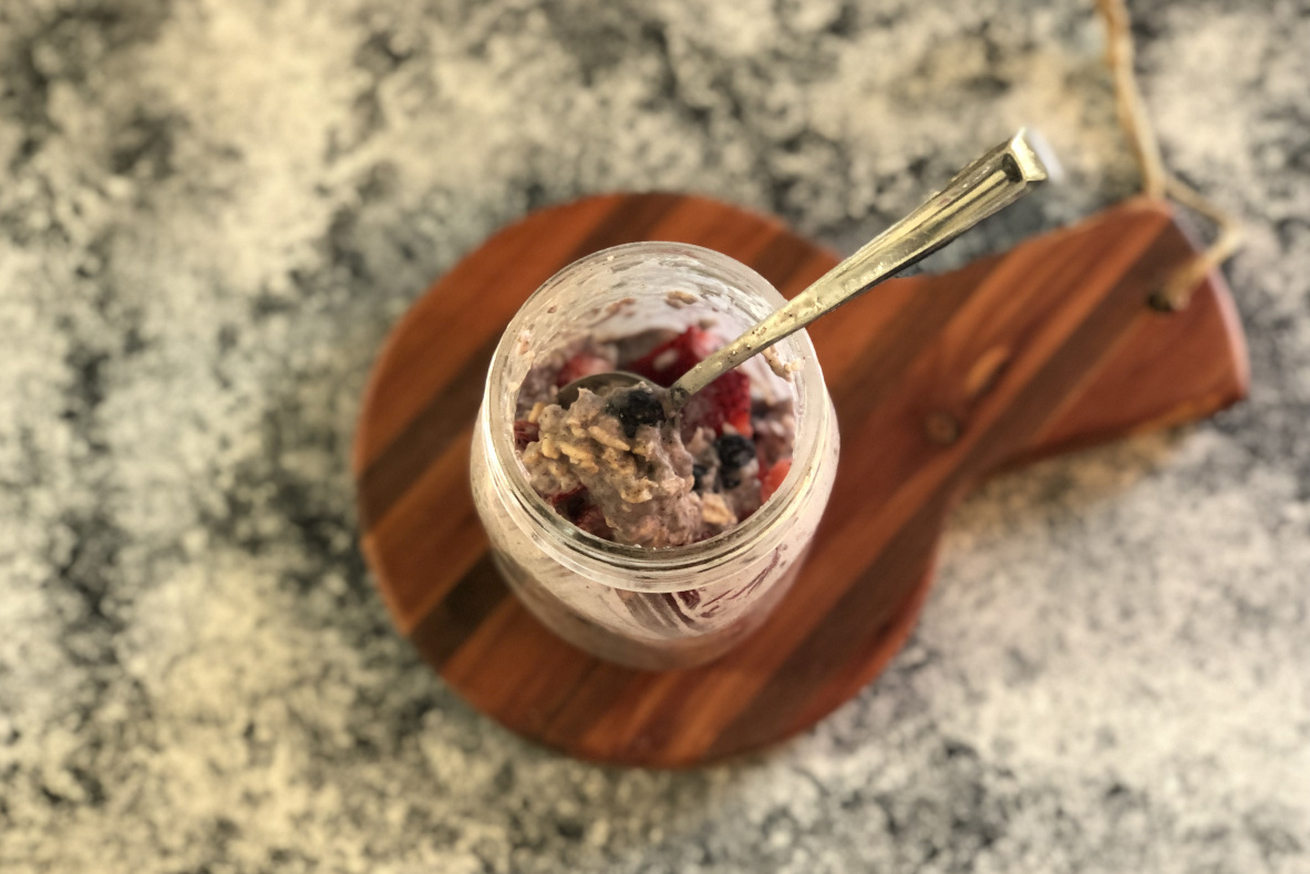 A jar of oatmeal with berries