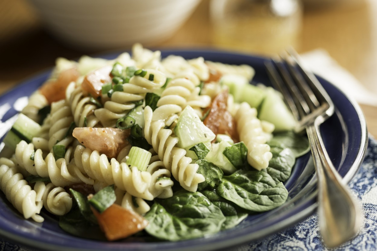 A plate of pasta salad with vegetables