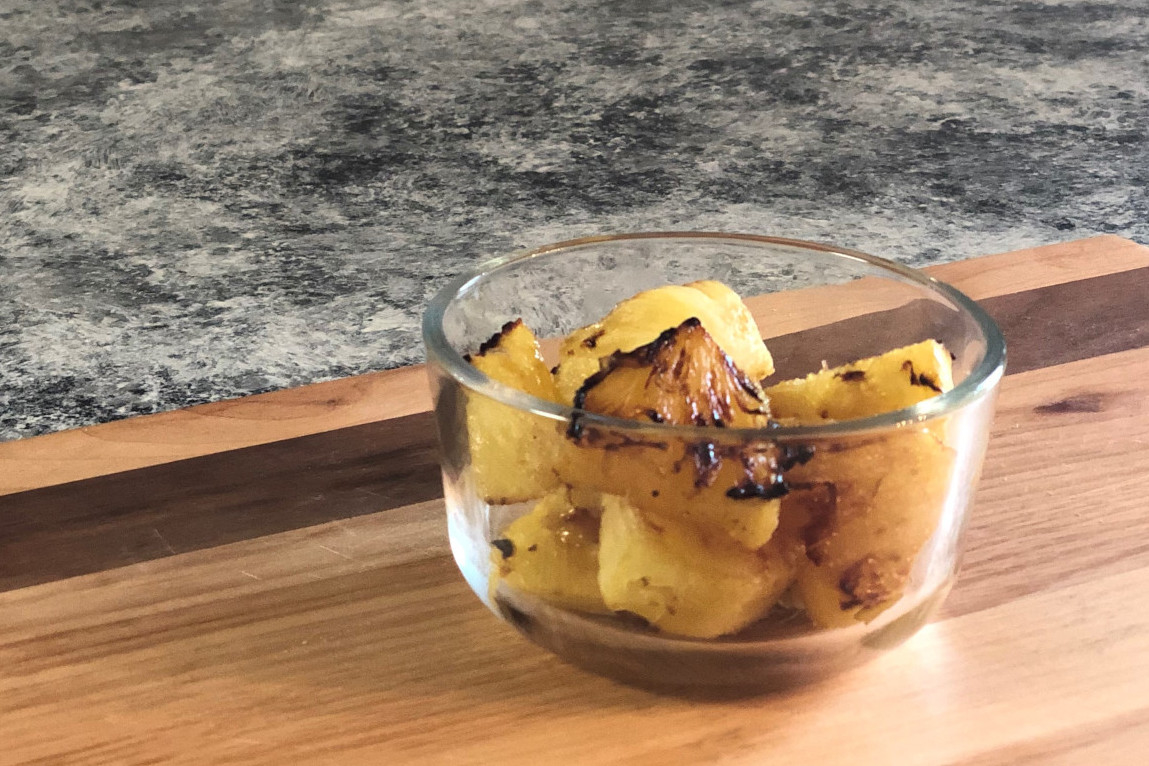 A bowl of roasted cubes of pineapple