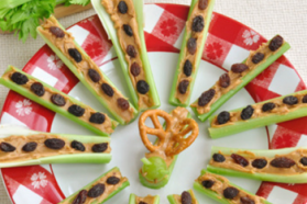 celery stalks with peanut butter and raisins arranged in a circle
