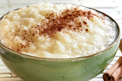 A bowl of rice pudding dusted with cinnamon