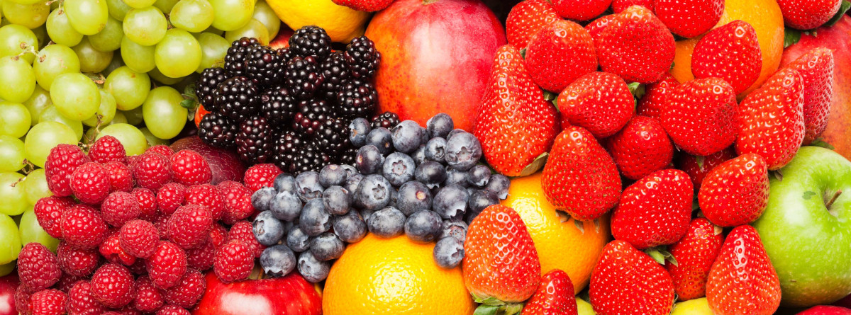 Various fruits including raspberries, strawberries, blueberries, blackberries, green grapes, green and red apples and oranges